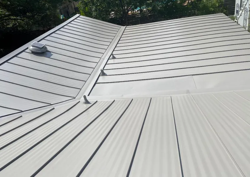 Solar attic fan installed on a metal roof for Roof Ventilation in Keokuk